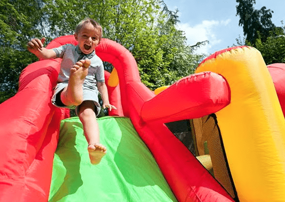 kids sliding on bounce house About Us